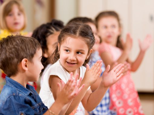 Kindergarten children clapping hands