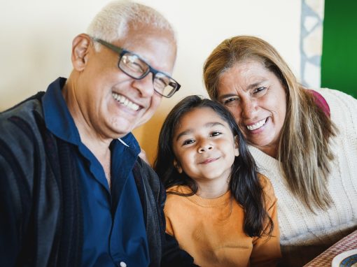 2 older adults and young girl smiling
