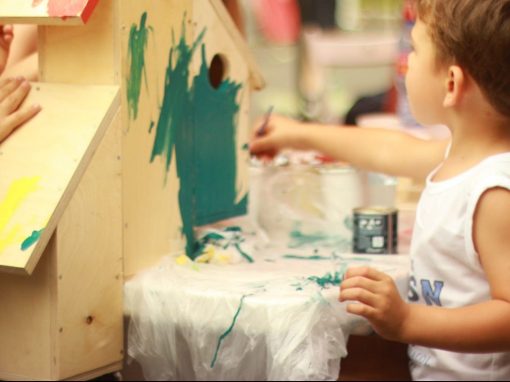 Kindergarten child painting wooden structure