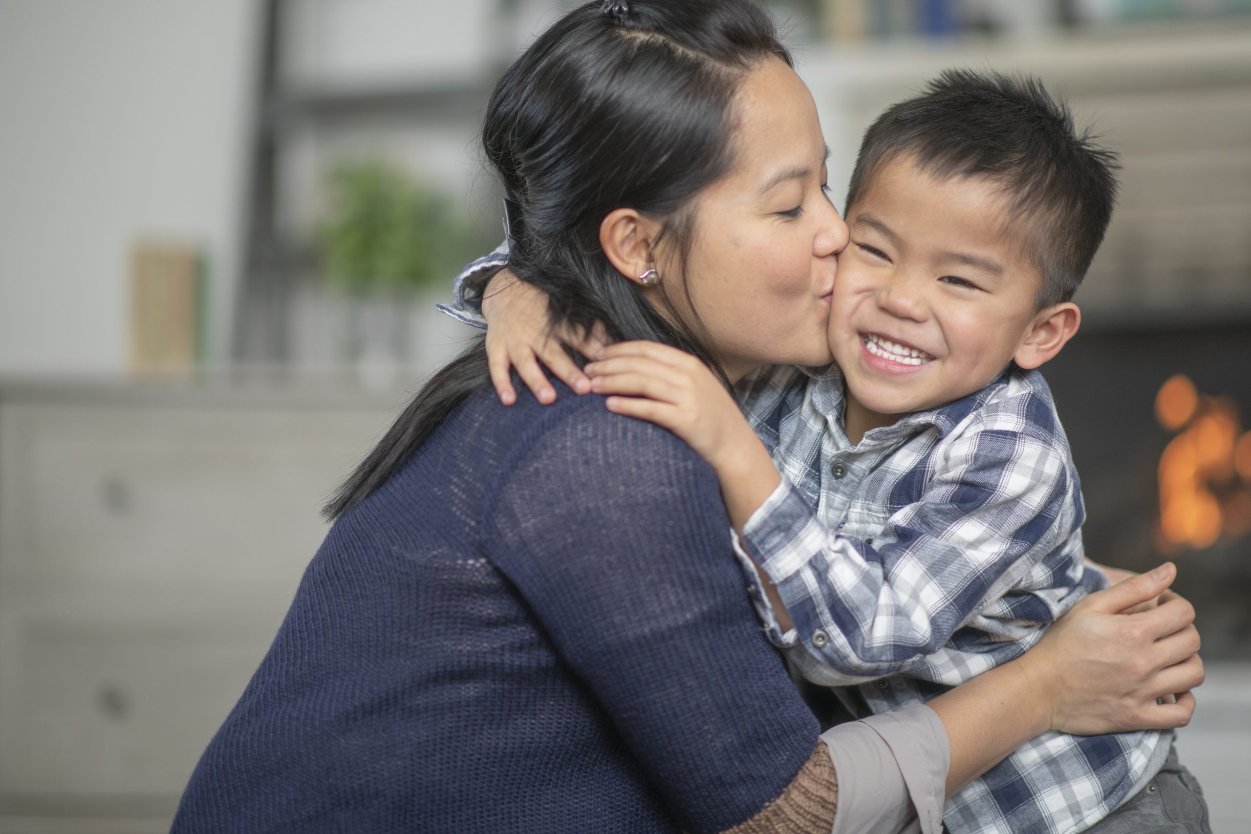 Mother kissing son on the cheek