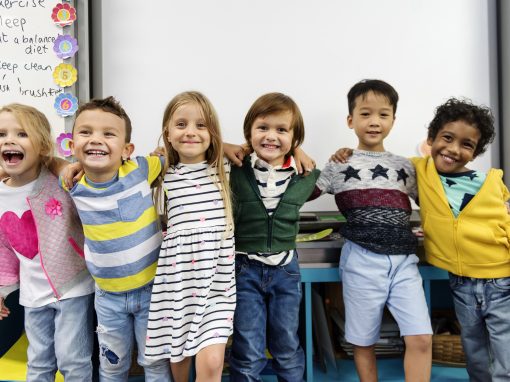Group of kindergarten children with their arms around each other