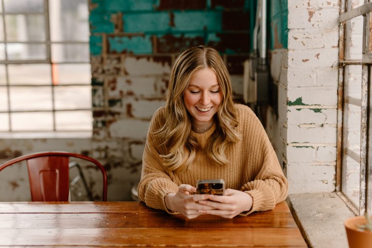 Young girl on phone in cafe