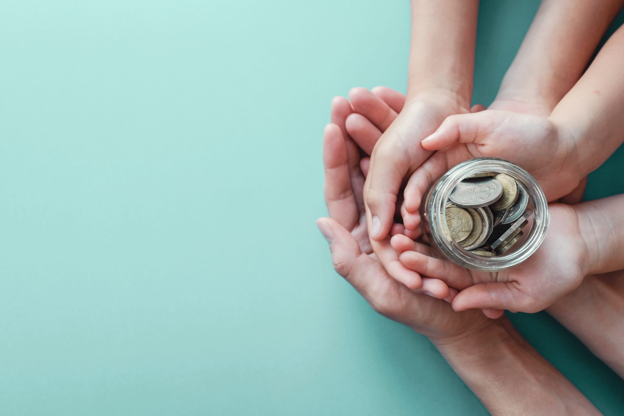 Child,And,Adult,Holding,Money,Jar,,Donation,,Saving,,Fundraising,Charity,